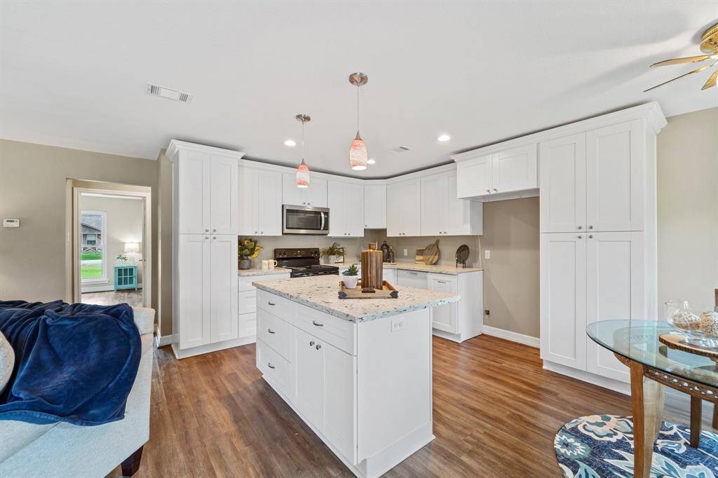 Experience luxury in this elegant shower, featuring modern glass doors, intricate tile work, and built-in shelving for a spa-like retreat at home.