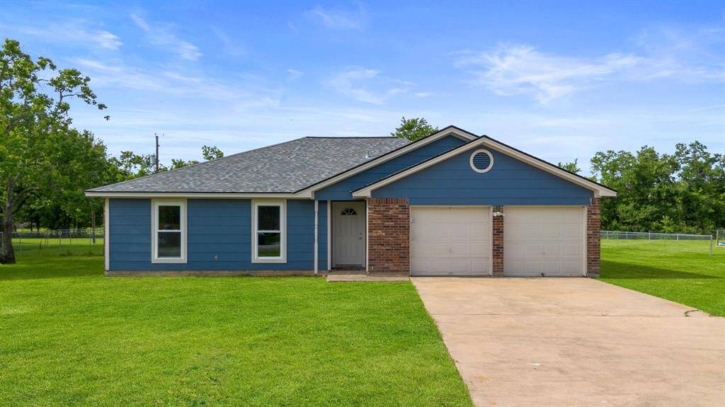 This home is surrounded by lush greenery, offering a serene setting.