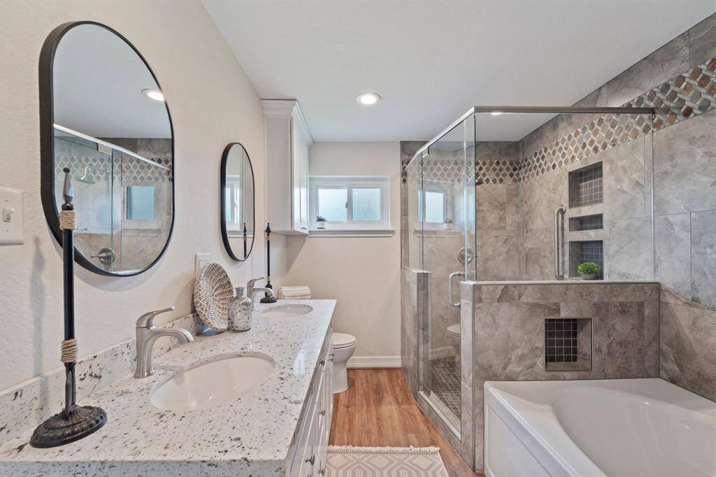 This comfortable, peaceful bedroom has a delightful front yard view.