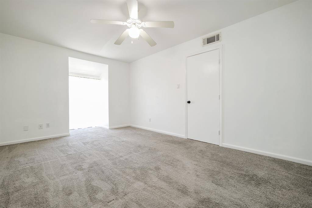 Primary bedroom with a large window, great for letting in natural light!