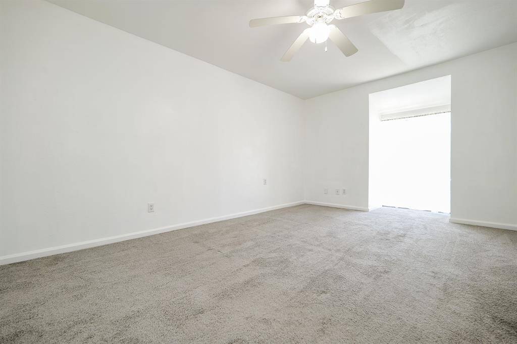 Spacious primary bedroom equipped with a ceiling fan!