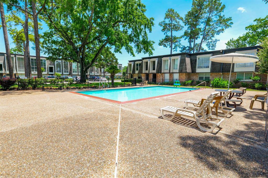 Luxurious pool area surrounded by large trees!