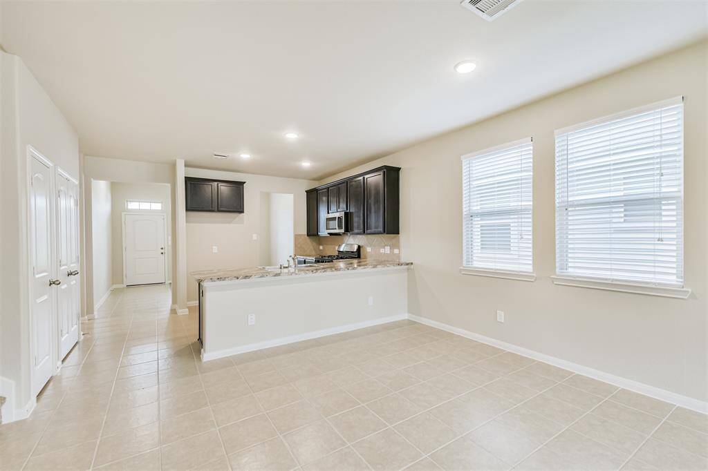 The Dining Area has Nice Tile Floors with Bright, Clean Grout! Once Again, Wonderful Natural Light Streams Through the Large Windows!
