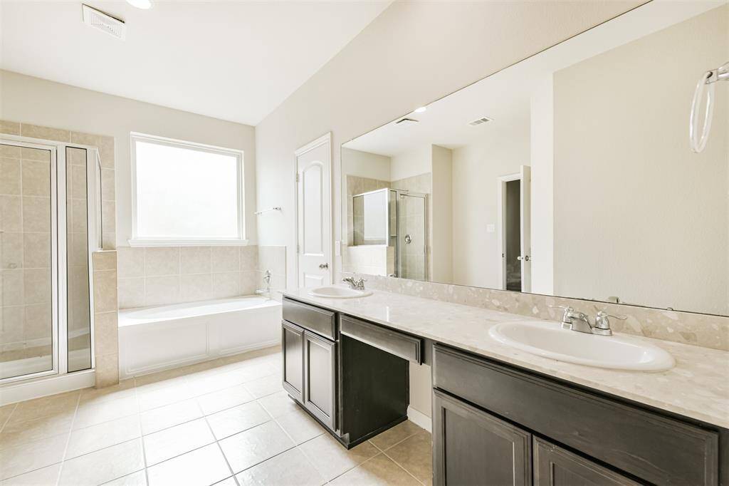 Primary Bath has Both a Luxury Soaking Tub and Separate Shower! Love the Large Mirror, Seated Makeup Space and Dual Sinks!