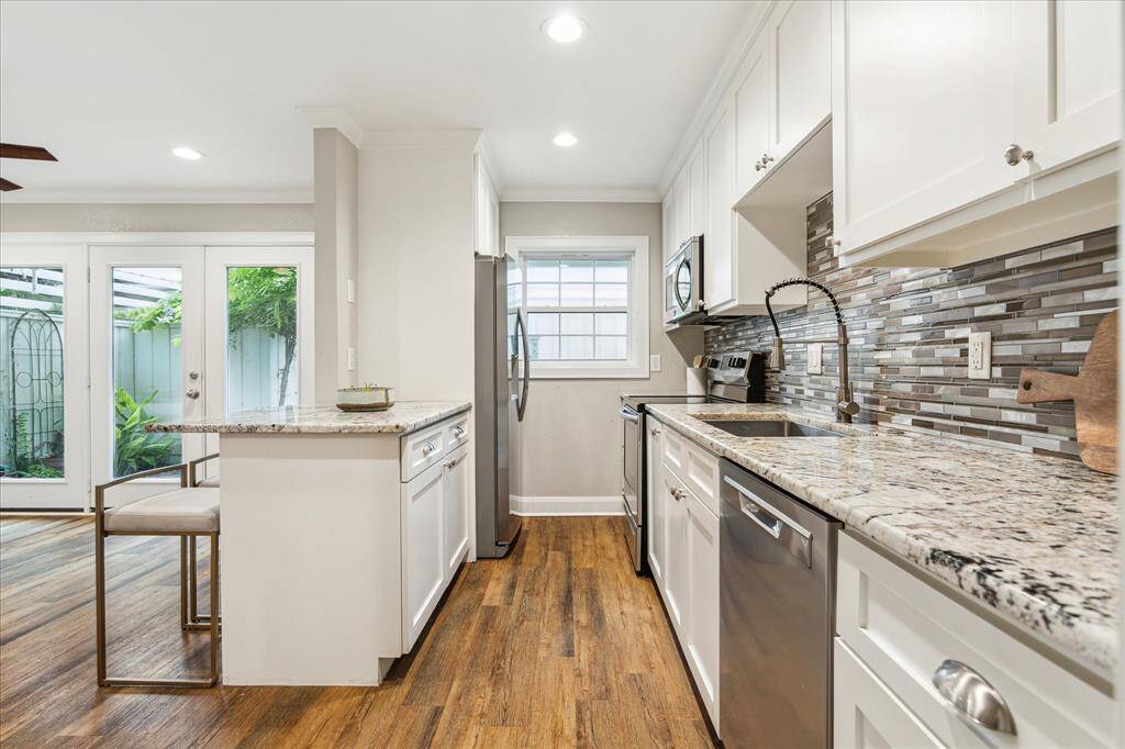Enjoy natural light and a backyard view while you cook—this thoughtfully designed galley kitchen is both beautiful and efficient.