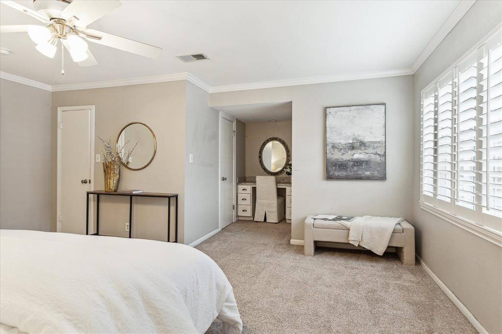 A thoughtfully designed layout includes a dressing vanity and direct access to the large walk-in closet and en suite bath.