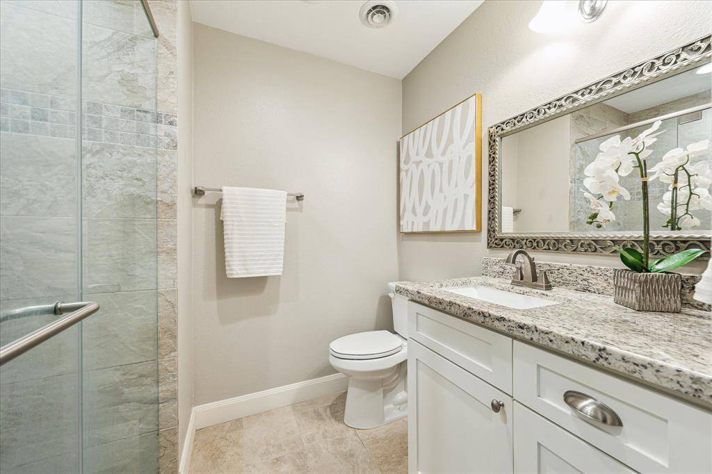 With elegant finishes and a soothing color palette, the primary bath is both practical and polished.