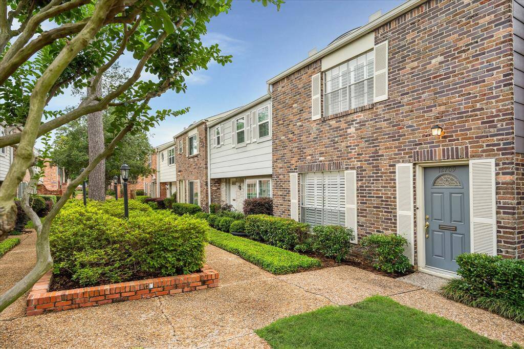 Enjoy serene, garden-style living with manicured hedges, charming lamp posts, and a peaceful walkway leading to your private entrance.