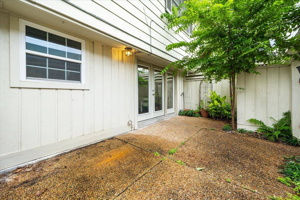 Step out back to your own private patio retreat—framed by greenery and perfect for outdoor dining or relaxing.