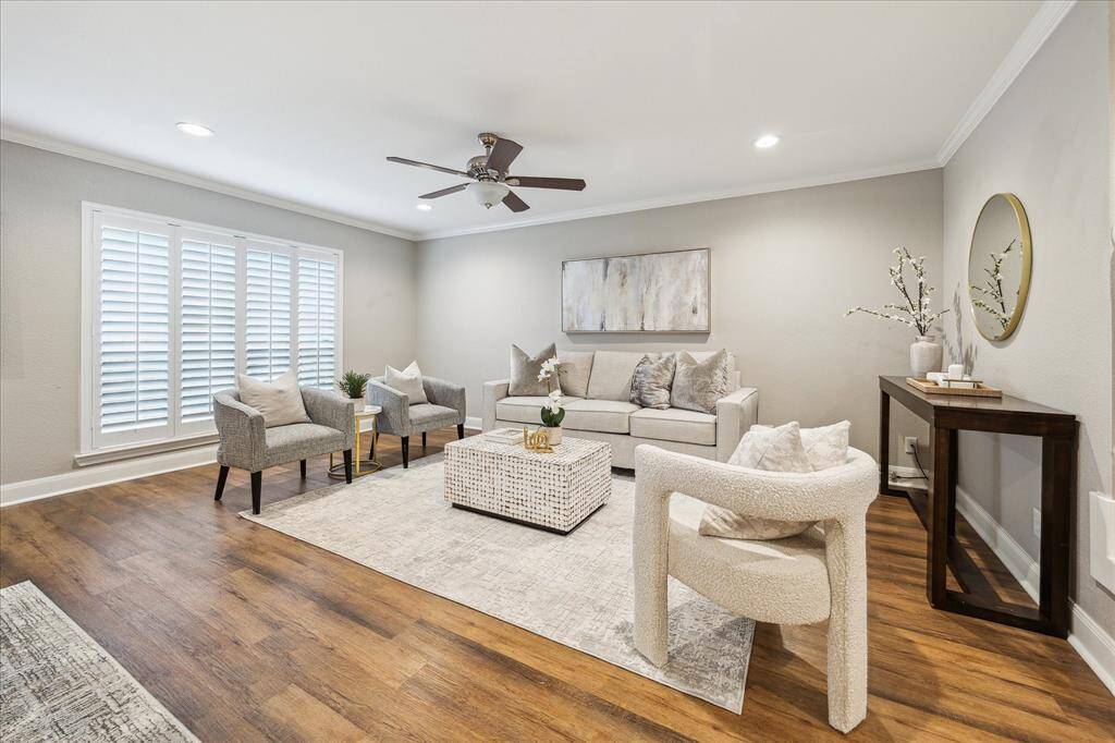 Welcome inside! Sunlight pours through plantation shutters in this warm and inviting living room—an ideal space for relaxing or hosting guests.