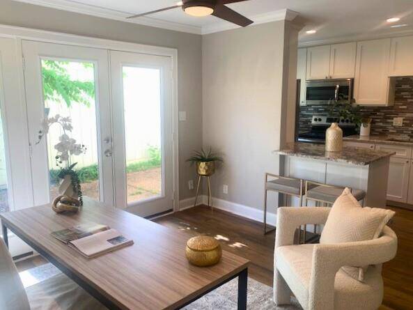 Natural light pours in through the French doors, with view of the courtyard