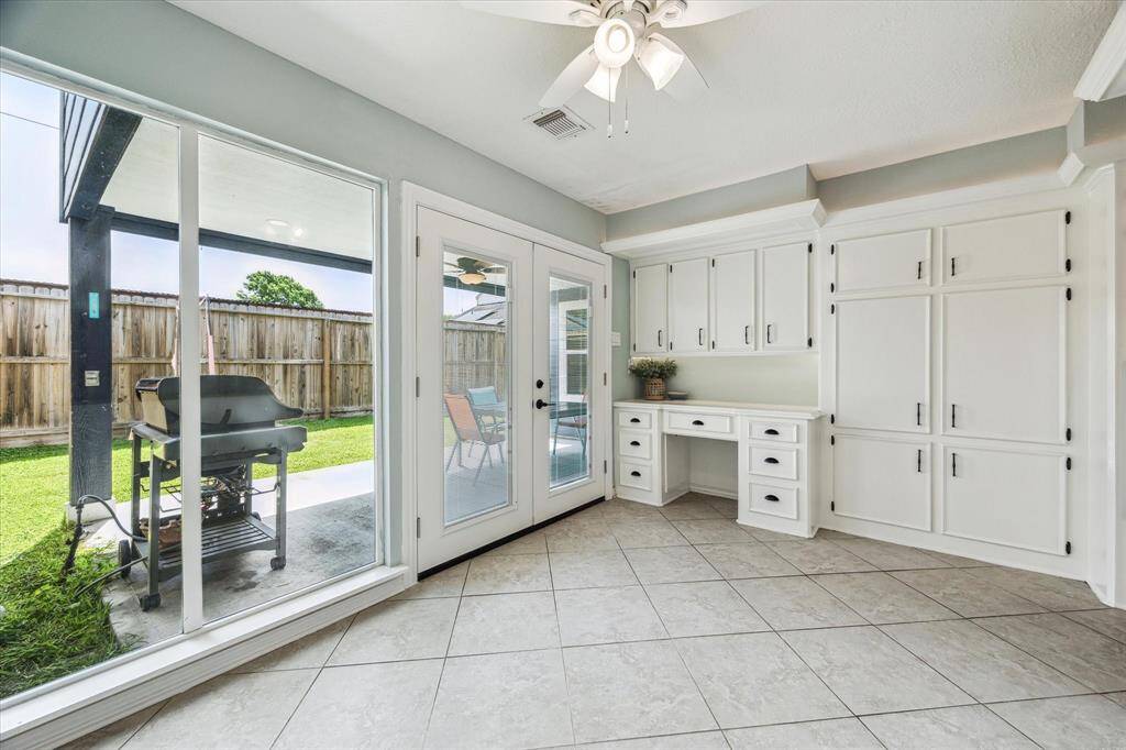 Start your day in the light and bright breakfast nook, with a glass wall and double French door that fill the space with natural light. This cozy corner offers plenty of cabinet storage.
