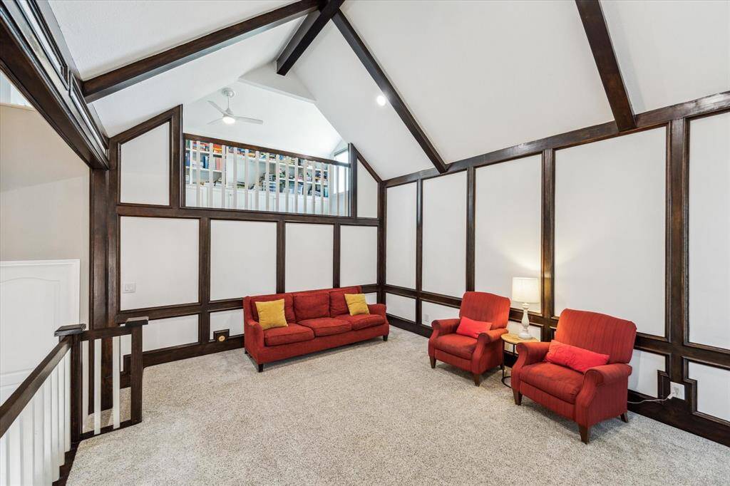 This inviting living space boasts soaring high ceilings and brand-new carpet flooring, offering a refreshed and spacious feel. - perfect for entertaining.