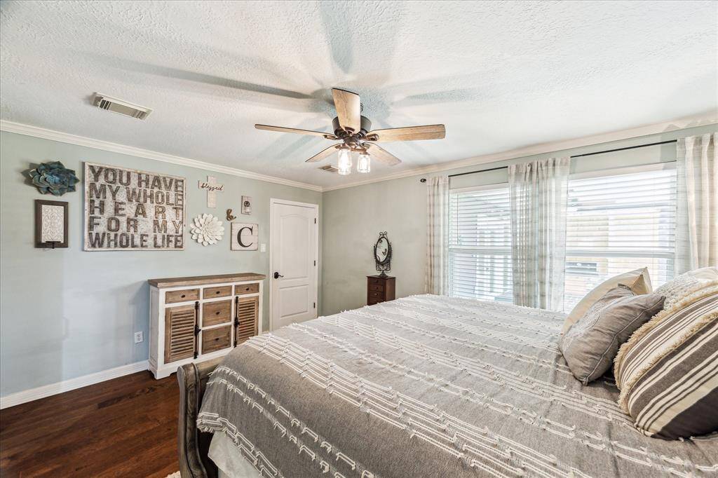 Enjoy the peaceful ambiance of the primary bedroom with large windows that welcome in morning sunlight. Recent updates include new interior and closet doors.
