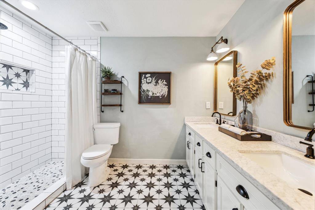 Enjoy the spacious walk-in shower adorned with floor-to-ceiling subway tiles.