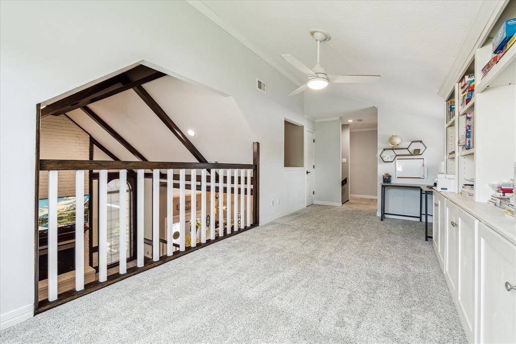 The game room is ideally situated just above the family room, featuring a balcony that overlooks the space below—making it a perfect spot for kids to hang out and play while staying connected to family activities.