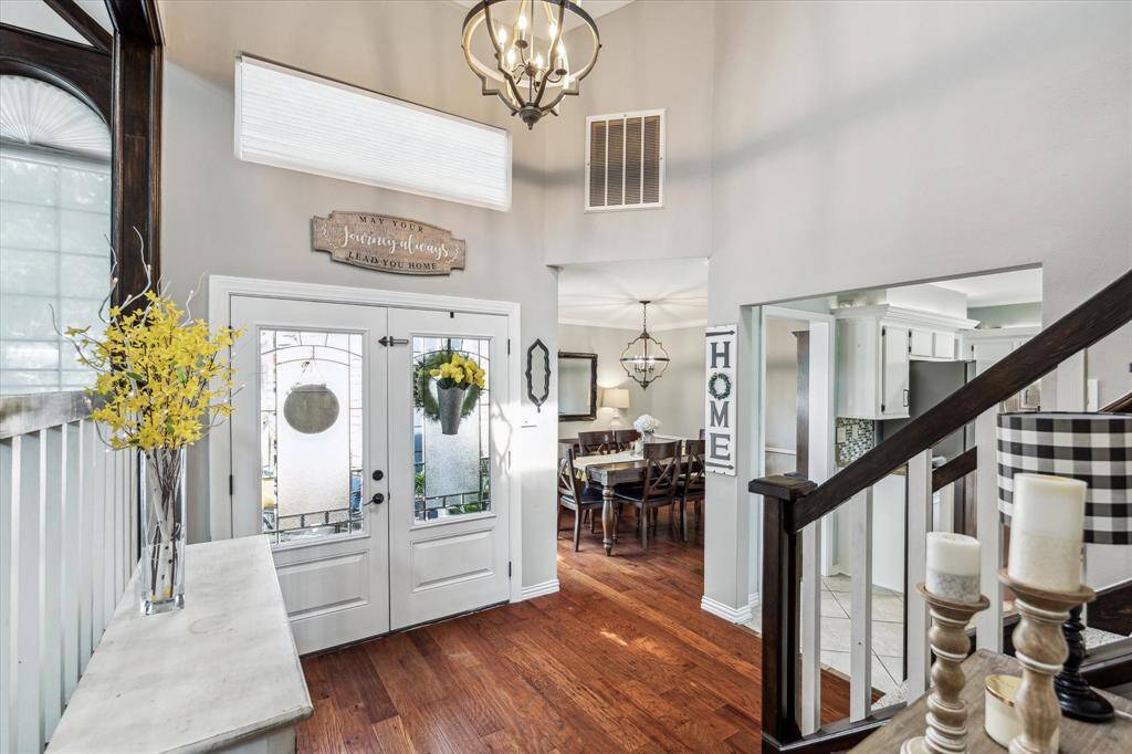 This angle captures the open flow from the dining area to the kitchen, complemented by updated modern lighting.