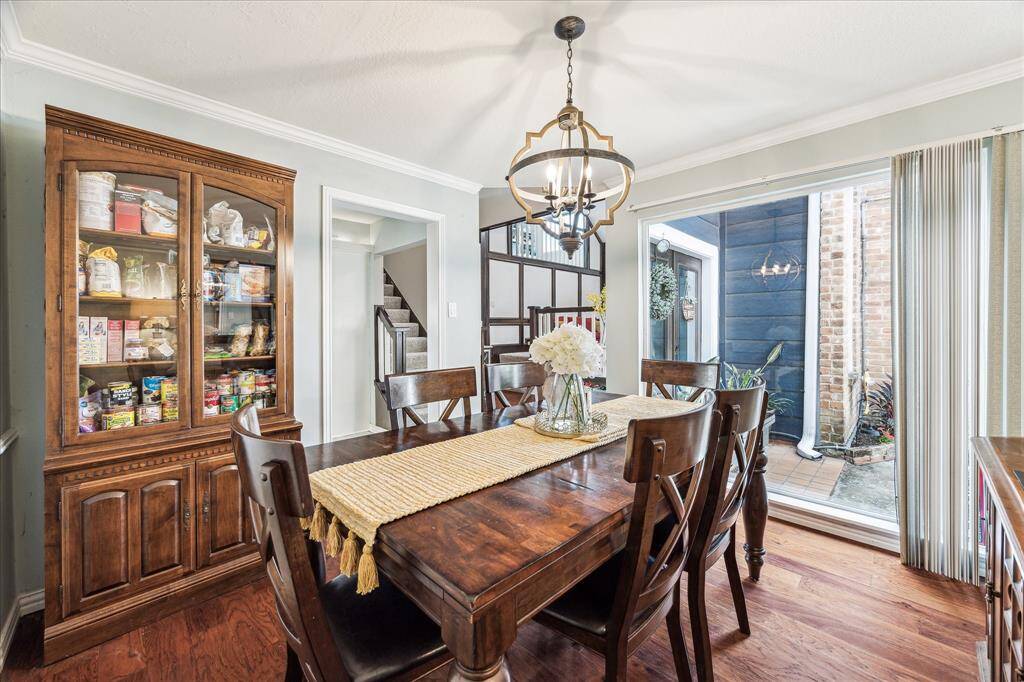 A full glass wall floods the dining area with natural light. The open floor plan seamlessly connects the space to the kitchen and living areas, making it ideal for entertaining.
