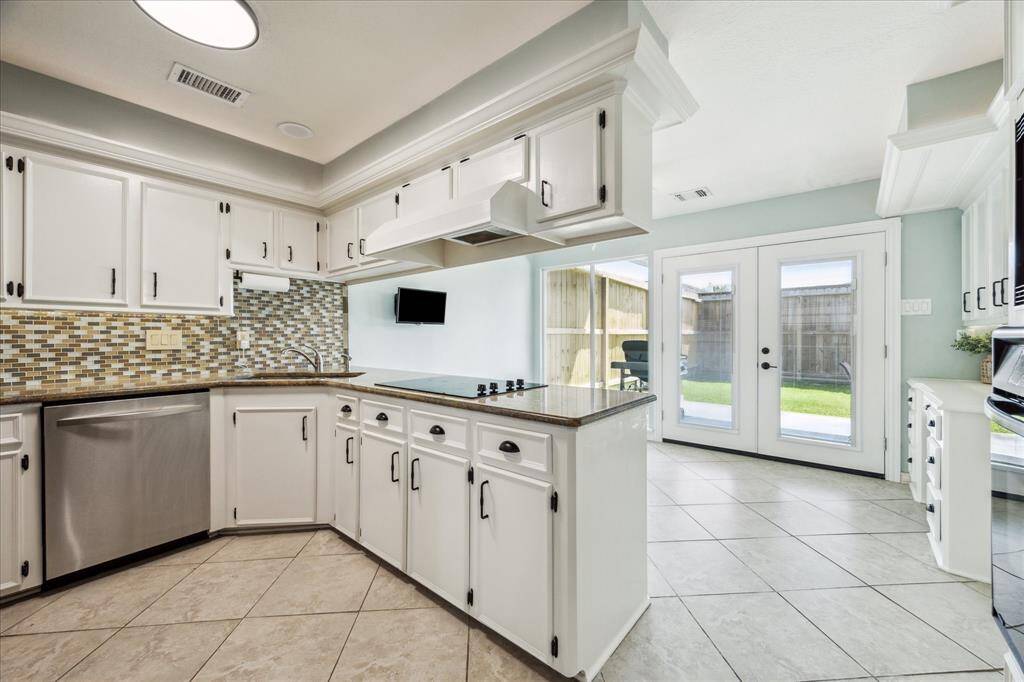 Kitchen features stainless steel appliances, an electric cooktop, double deep sink, and a brand new garbage disposal.