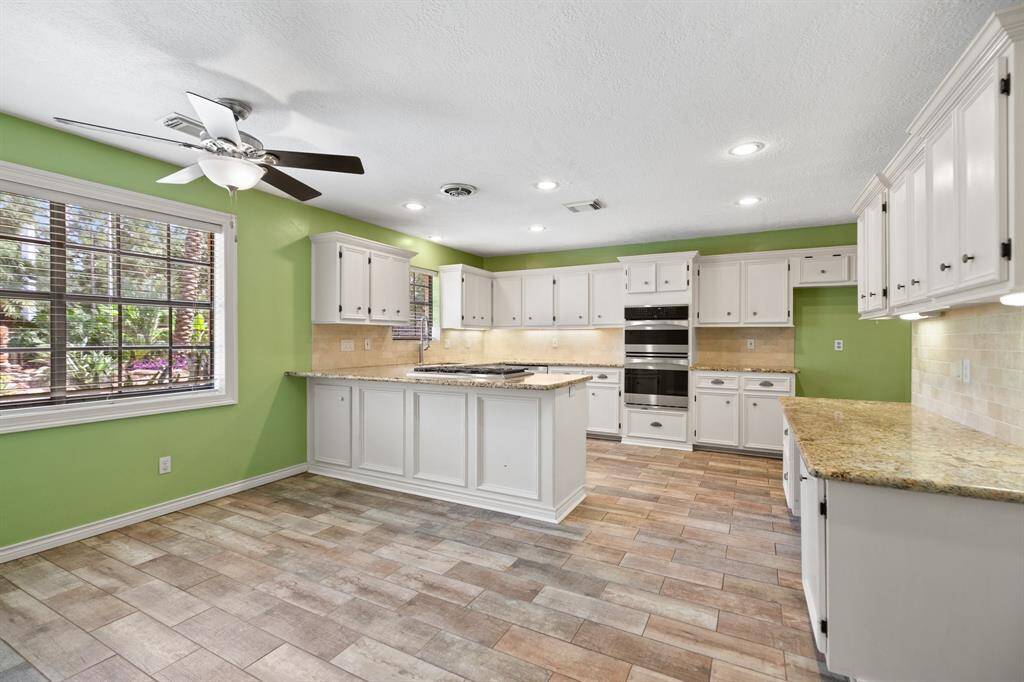 Huge kitchen space overlooks the pool.