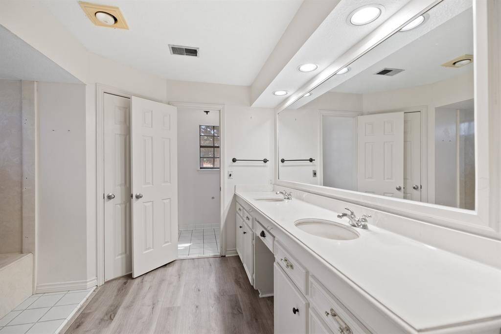 Primary bath with dual vanity.