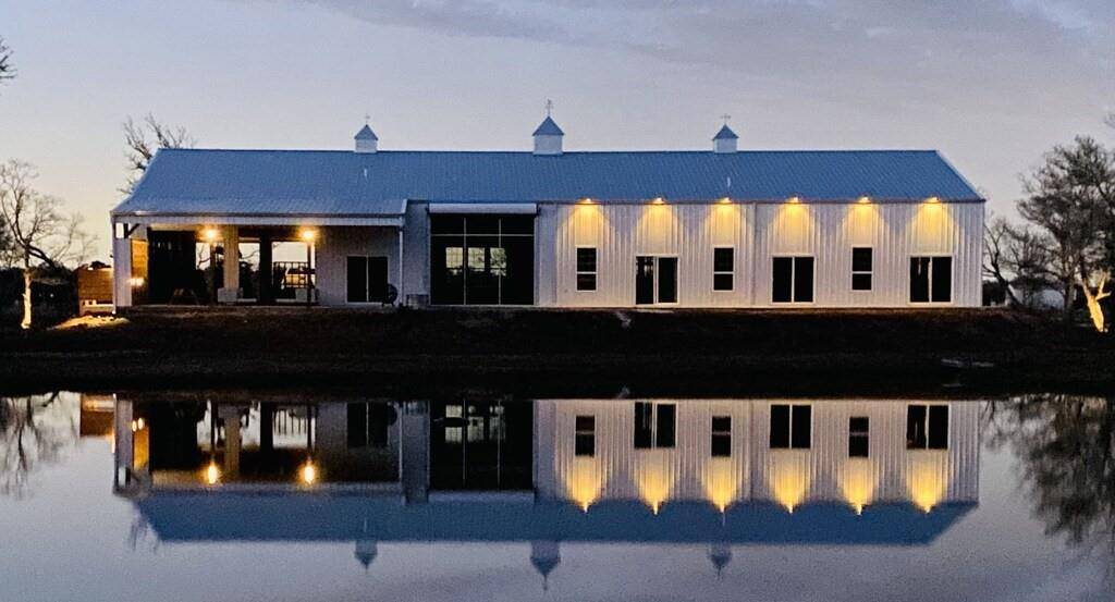 Evening view from back of home. Notice the two garage doors open on this side as well.