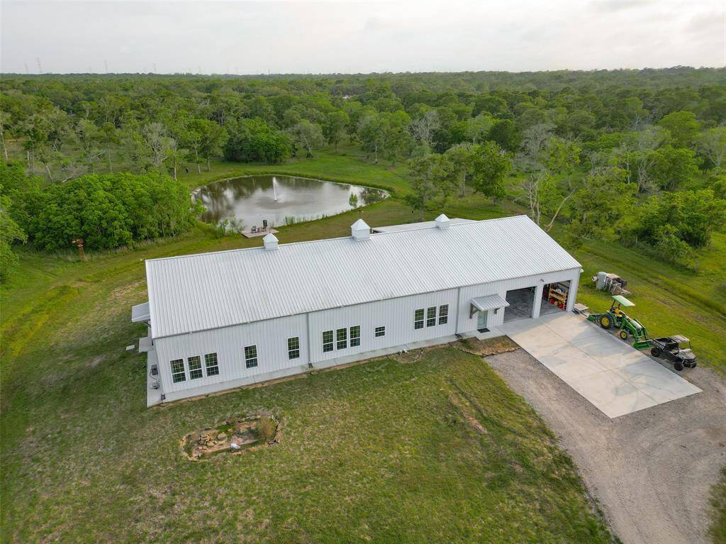 Aerial of front of house, pond at back visible