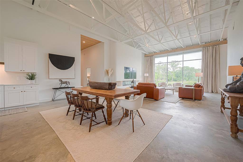 View of kitchen, breakfast room and living room. Notice the built-in TV/fireplace and expansive back window.