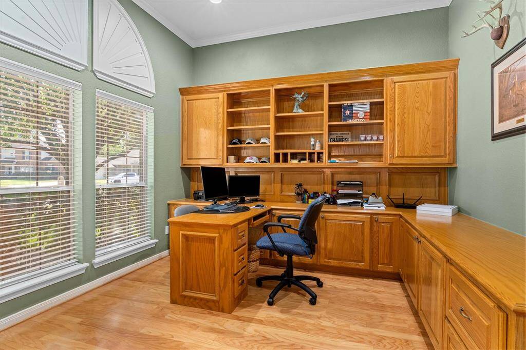 Through the french doors to the left when you enter, there is an office with beautiful custom built-in cabinets, desk and bookcase.  Big windows and above cabinet lighting makes this office a bright place to work!
