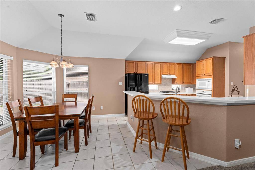 Quaint Breakfast area off the kitchen with windows offering tons of natural light!