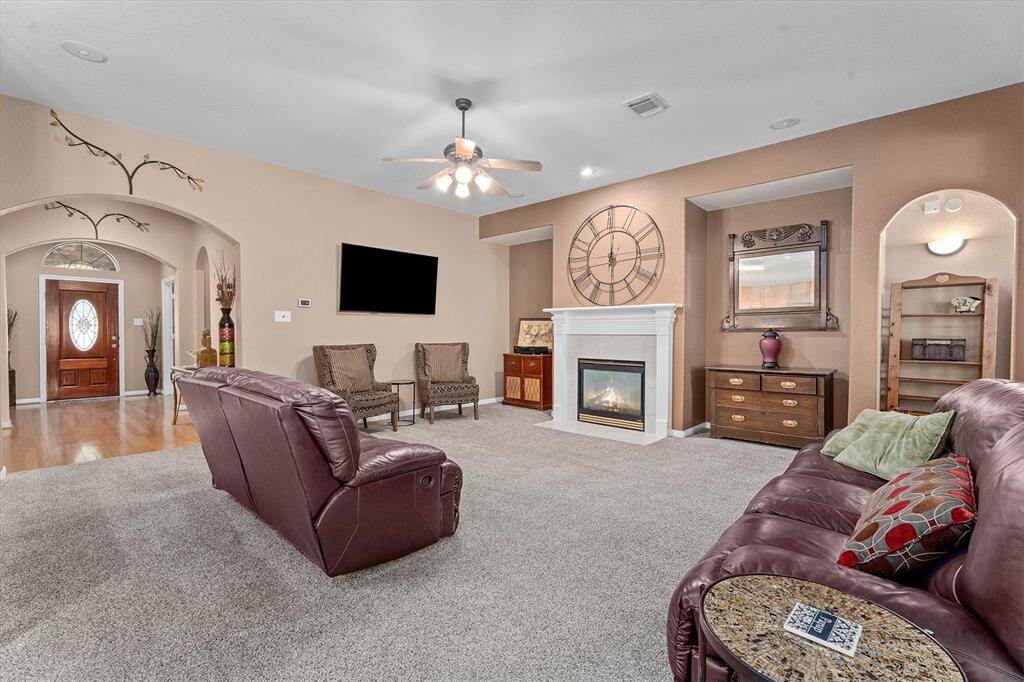 Spacious family room with gas fireplace! Love all the arched doorways!