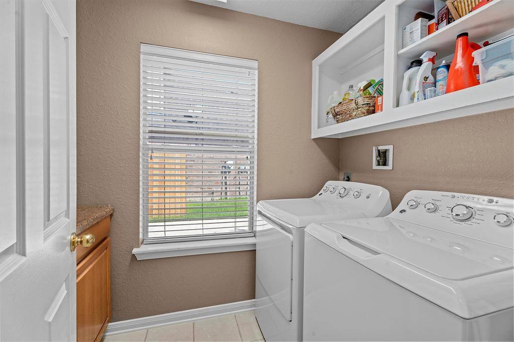 Laundry Room is conveniently located and has built in shelves and cabinets.  Washer and Dryer stay with the home!