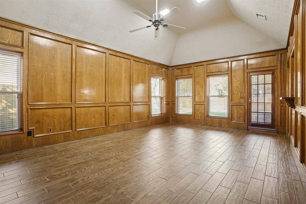 Another view of family room showing access to backyard and loads of windows.