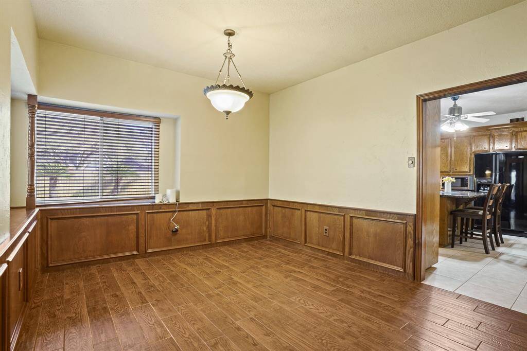 Huge formal dining room conveniently located between kitchen and family room with attached wet-bar
