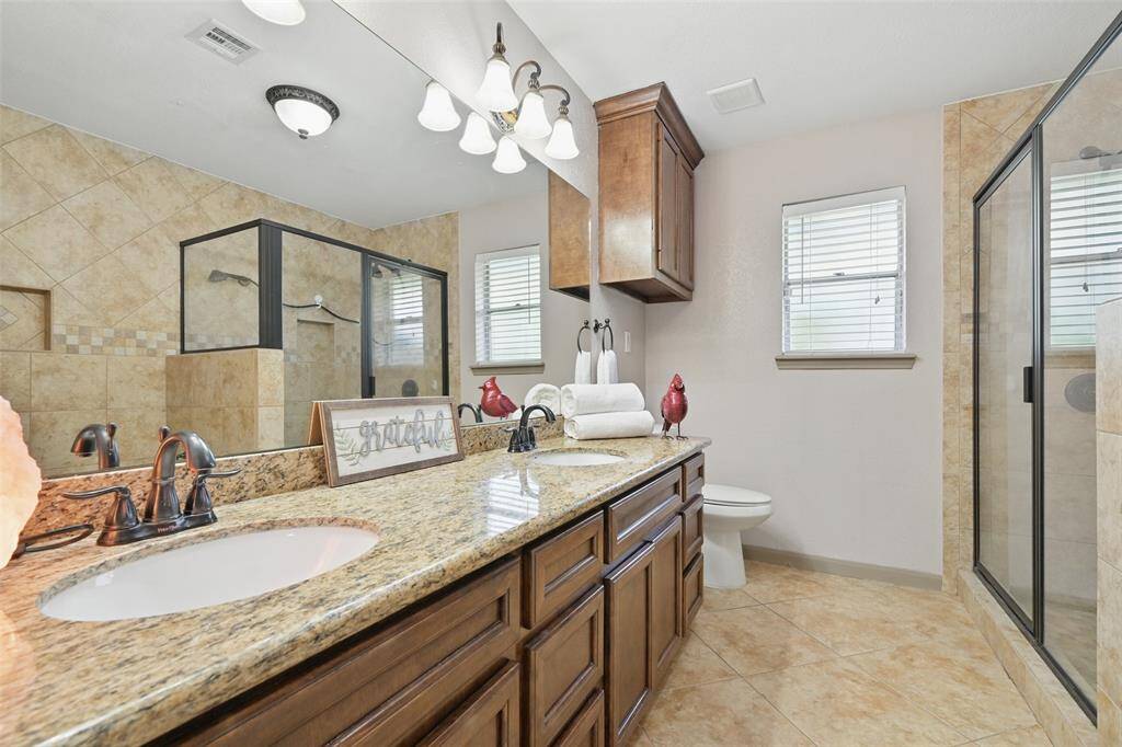 Primary bath with dual sinks, large walk in shower and separate tub.