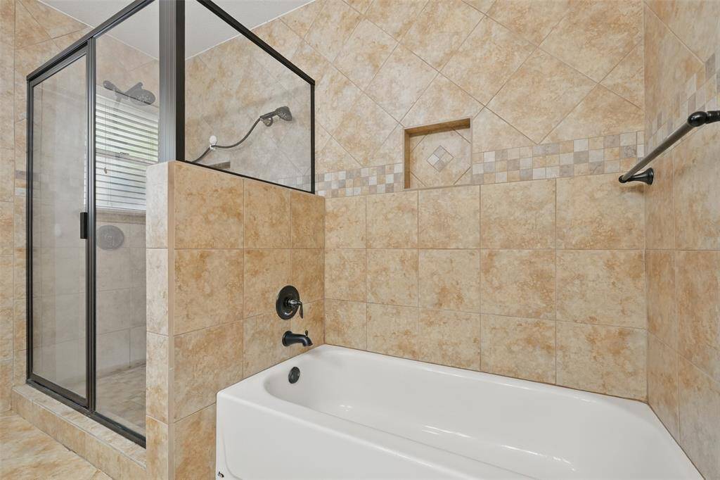 Primary bath with separate shower and soaking tub. Easy to maintain tile floors and wall.