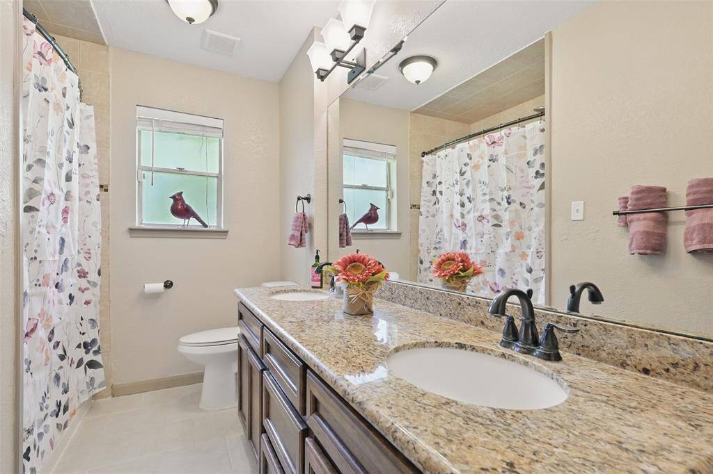 Second bath with dual sinks, granite counters, updated paint.