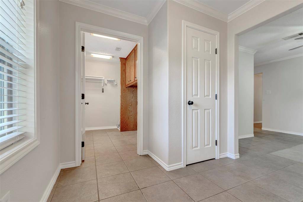 From the dining area, you can view the closed pantry and the door leading to the laundry area.