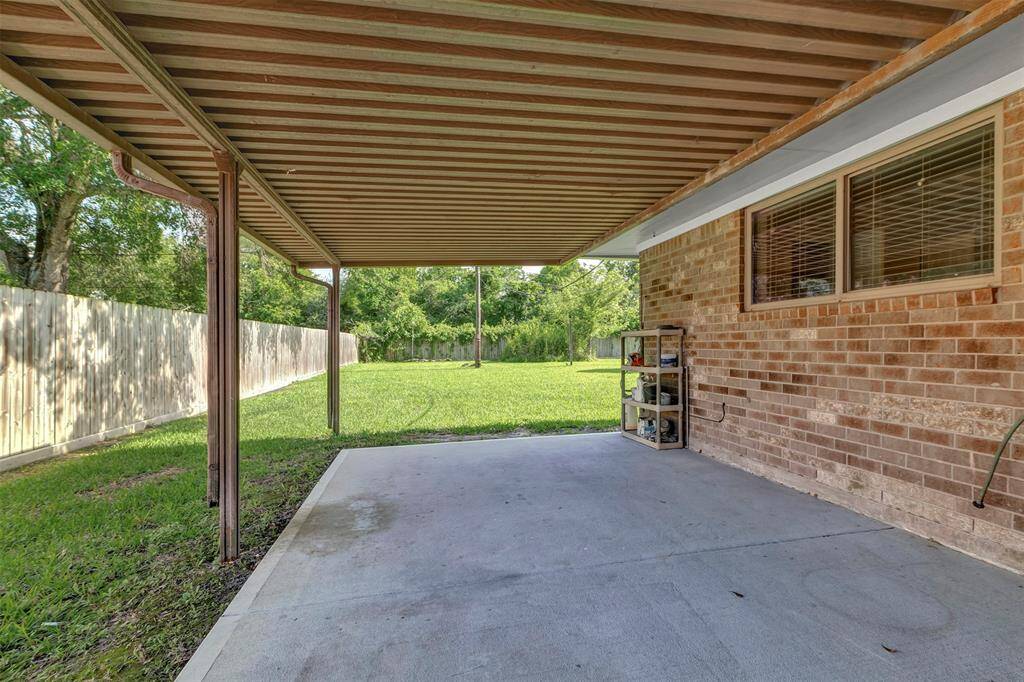 At the back of the house, you'll find a spacious covered patio, perfect for lounging and outdoor dining.