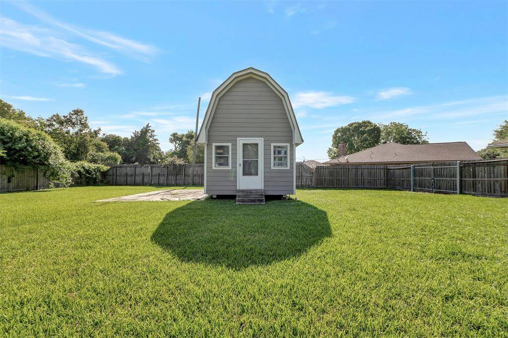 At the center of the lawn sits the shed—a convenient storage space for tools, equipment, and more.