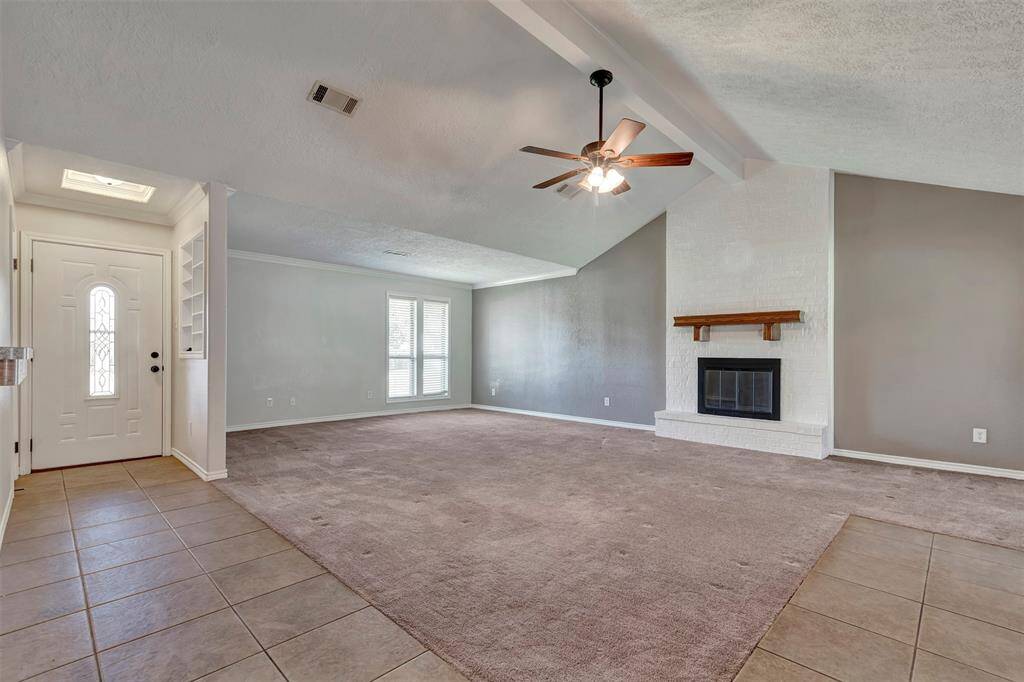 Step inside and find the spacious living room just to your left—an ideal spot to relax or entertain.