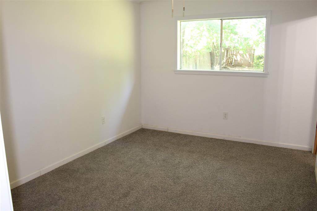 Primary Bedroom showing window that overlooks backyard.