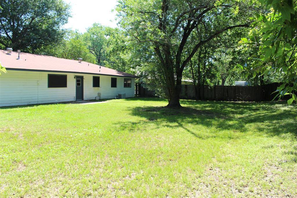 Back yard has tons of room for play and mature trees for shade.