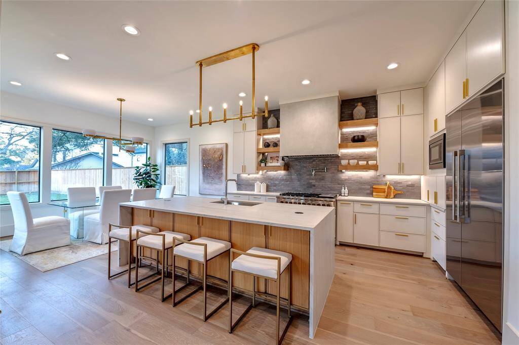 Previous construction by SF Custom Homes showing top tier finishes such as white oak cabinetry, oversized windows, twelve foot ceilings, visual comfort lighting and built in oversized appliances.