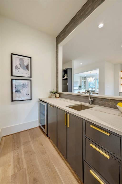 Previous construction beautiful wet bar with beverage refrigerator and inset cabinets.