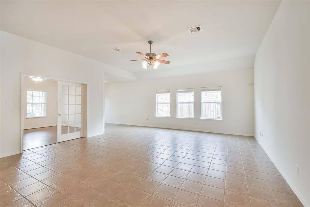Large family room with tile floors. View of private study.