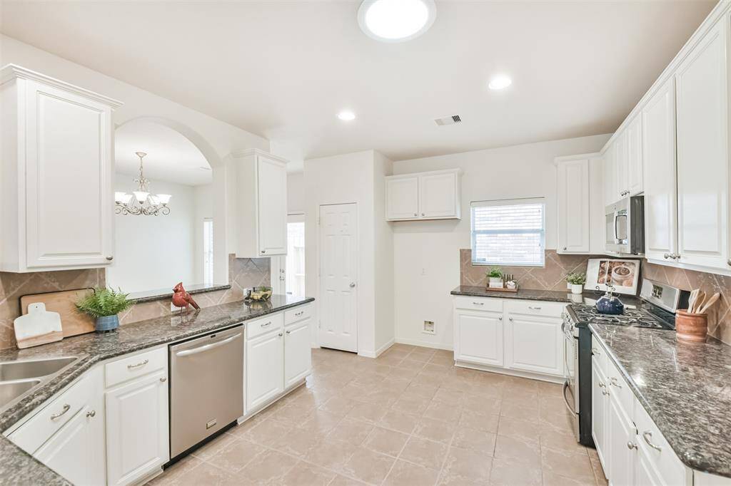 Updated kitchen with recently painted cabinets, granite counters, stainless appliances.