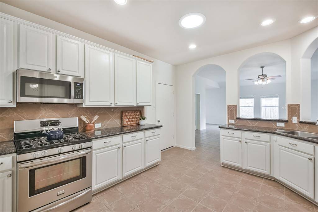 Garage is located off of kitchen-so bringing in groceries is a snap! Love the gas stove and ample supply of cabinets and entertaining space.