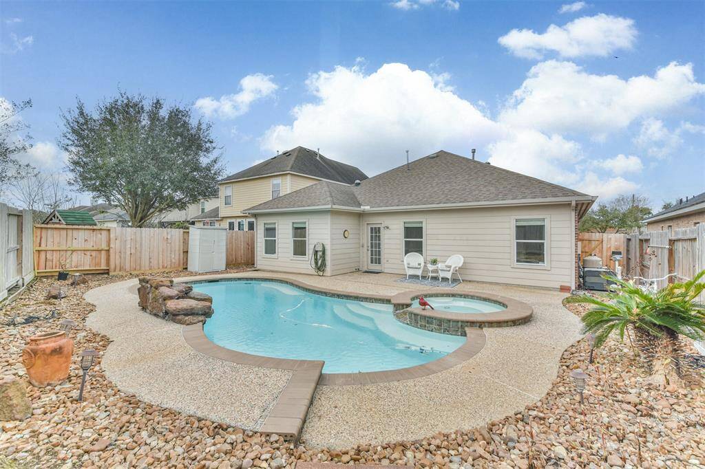 Easy to maintain backyard pool area. Rocks can be removed and grass added if needed.