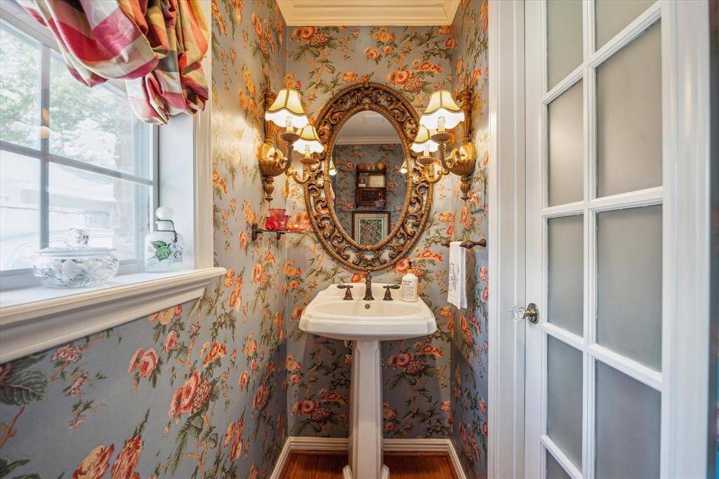 Discreetly tucked off the breakfast room, the powder bath offers a touch of convenience and elegance in its compact design.